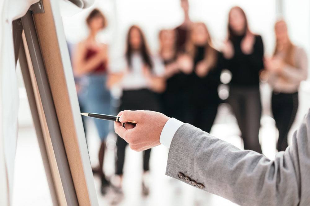 Geschäftsmann zeigt auf ein Flipchart